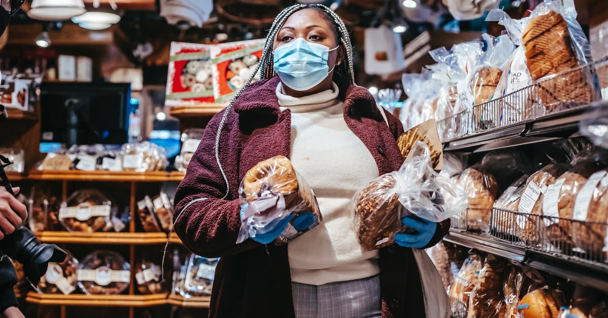 Is it safe to carry $10000? [closed] - African American female buyer in protective mask and gloves carrying loafs of bread in grocery store