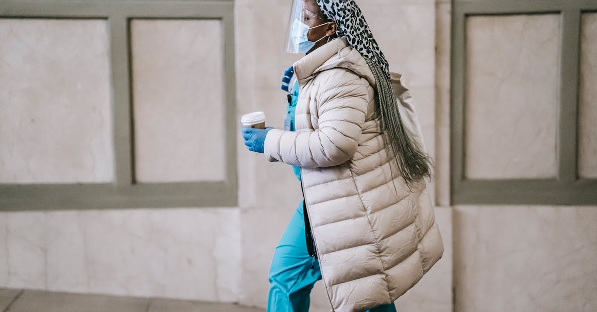 Is it safe to go to Içmeler, Turkey now? - Side view calm adult African American nurse in uniform and warm clothes wearing medical mask face shield and latex gloves walking with coffee to go on street Is it safe to go to Içmeler, Turkey now? - Side view calm adult African American nurse in uniform and warm clothes wearing medical mask face shield and latex gloves walking with coffee to go on street