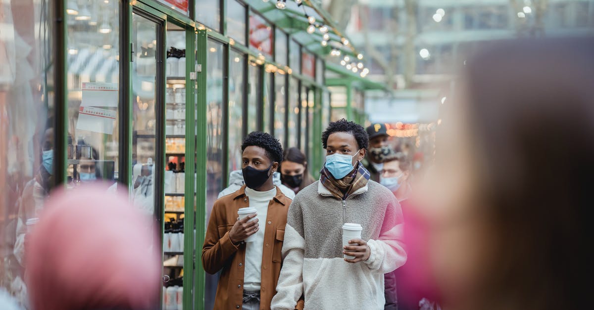 Is it safe to go to Içmeler, Turkey now? - African American homosexual male in protective masks holding hands while strolling on street with takeaway coffee on street with people Is it safe to go to Içmeler, Turkey now? - African American homosexual male in protective masks holding hands while strolling on street with takeaway coffee on street with people