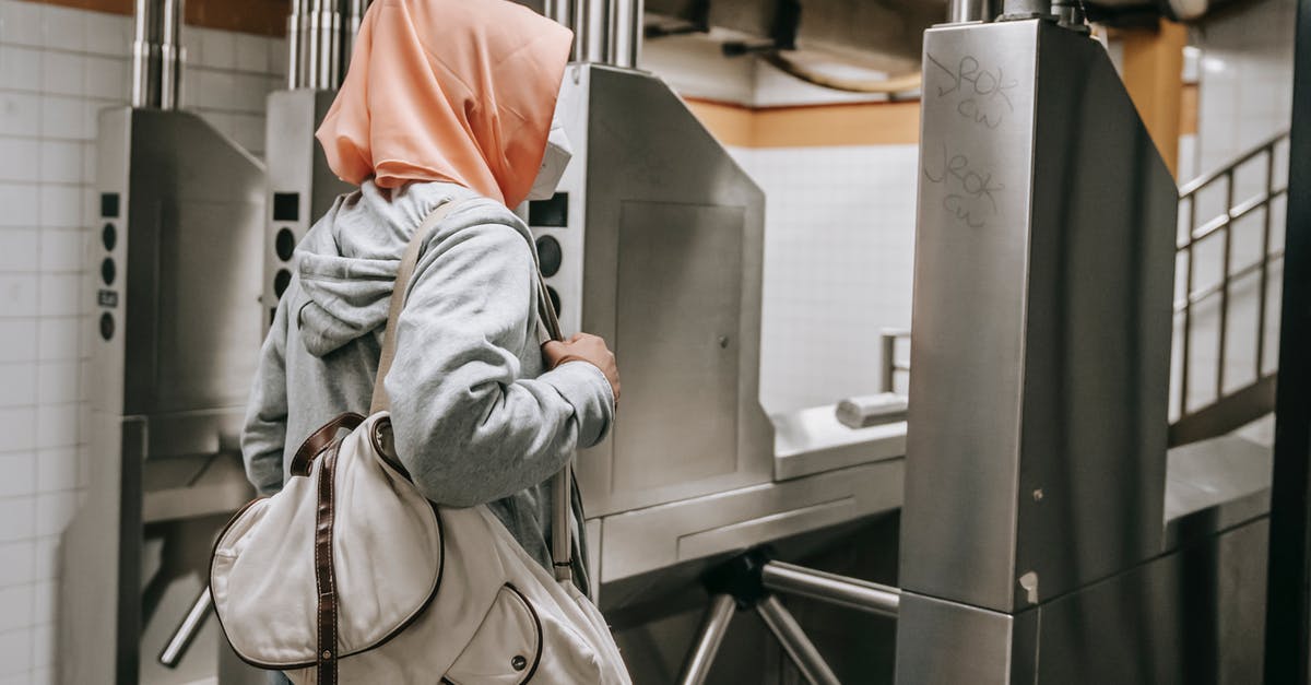 Is it safe to stand next to airport X-ray machines? - Side view of faceless Muslim female in casual outfit with protective mask and hijab in subway near turnstile with backpack Is it safe to stand next to airport X-ray machines? - Side view of faceless Muslim female in casual outfit with protective mask and hijab in subway near turnstile with backpack