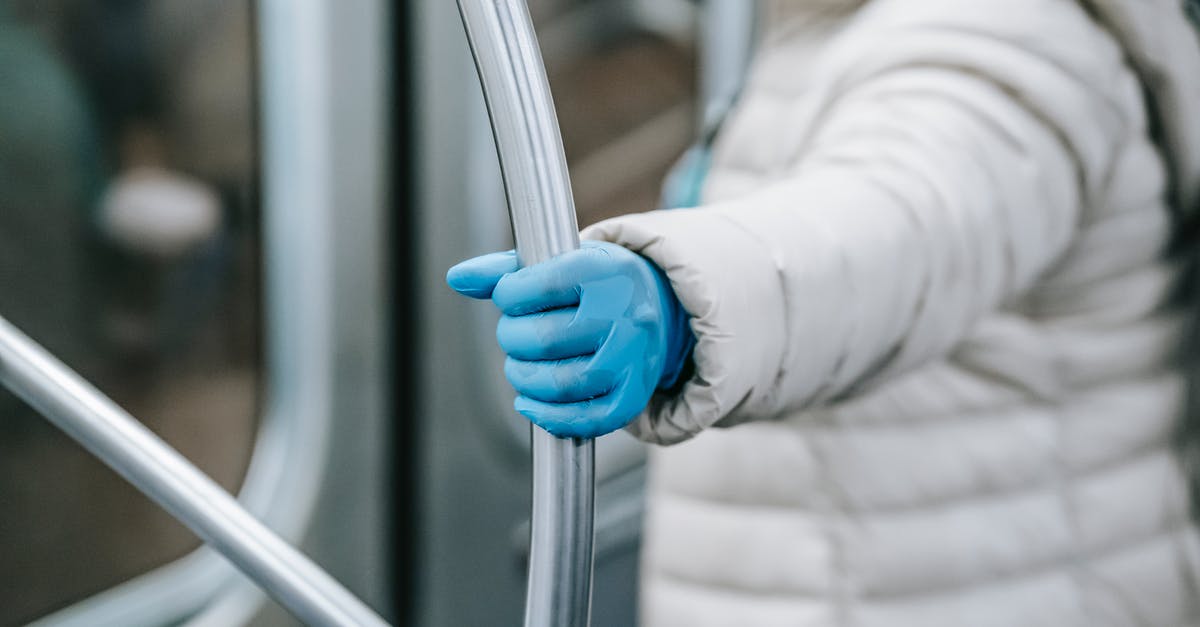 Is it safe to travel to Morocco due to the Ebola outbreak? [duplicate] - Side view crop person in outerwear and latex gloves holding handle and riding underground train during coronavirus epidemic