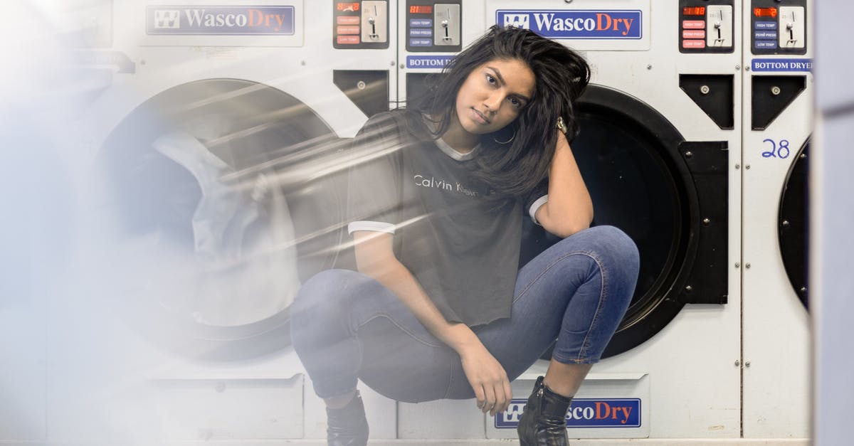 Is it the norm for hotels not to provide washing service for undergarments in India? - Woman in Black Shirt and Blue Denim Jeans Sitting on Front Load Washing Machine Is it the norm for hotels not to provide washing service for undergarments in India? - Woman in Black Shirt and Blue Denim Jeans Sitting on Front Load Washing Machine