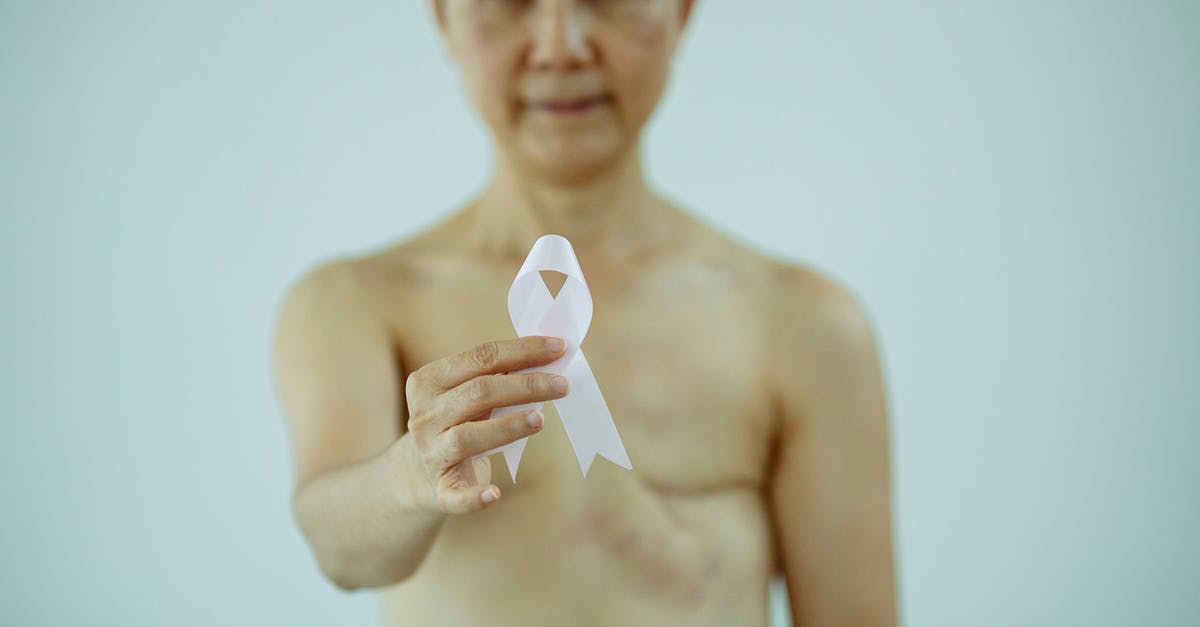 Is it true that a "dekoriert"-sign means that naked women are dancing? - Crop naked unrecognizable female with surgery scarring demonstrating symbol of breast cancer awareness Is it true that a "dekoriert"-sign means that naked women are dancing? - Crop naked unrecognizable female with surgery scarring demonstrating symbol of breast cancer awareness