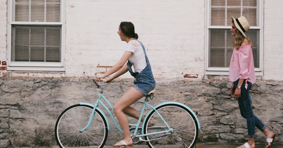 Is it true that children under 6 can legally ride a bicycle on the sidewalk in Denmark? - Woman Riding on Teal Cruiser Bike Near Woman Wearing Pink Long-sleeved Shirt