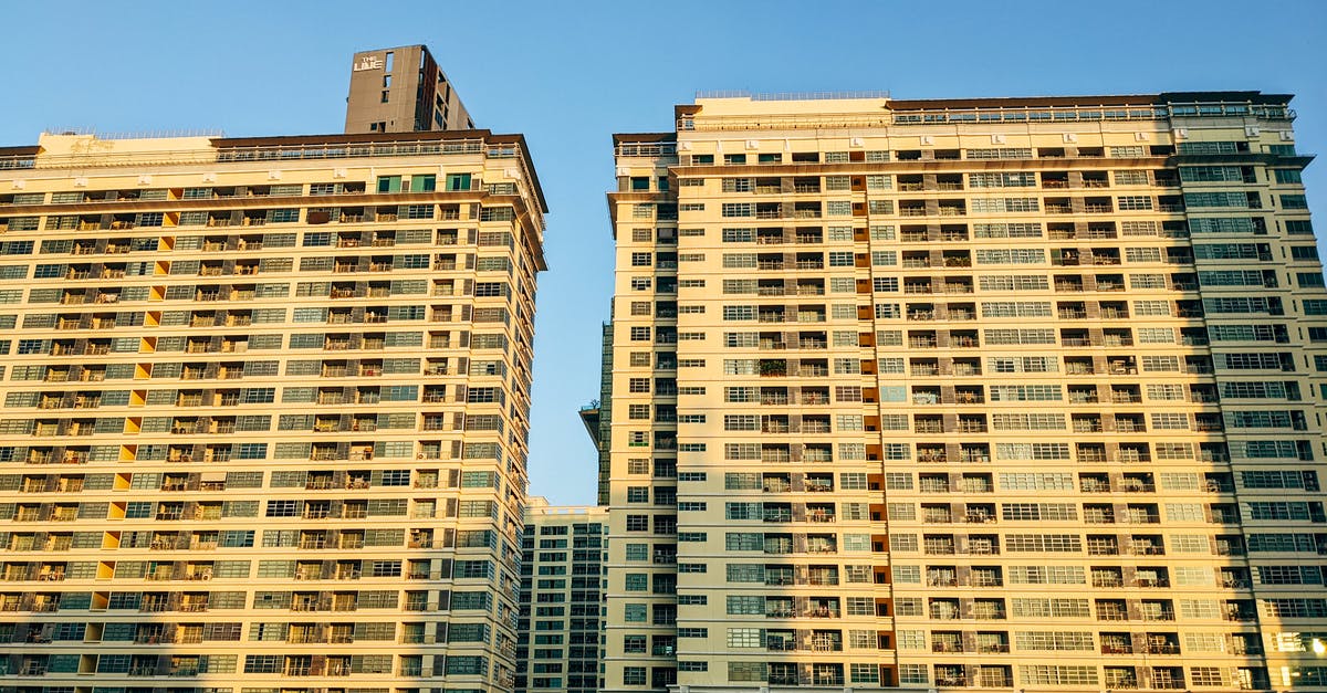 Is living in Thailand on a dependant visa termed as living in that country or visiting? - Concrete High Rise Building at Sunrise Is living in Thailand on a dependant visa termed as living in that country or visiting? - Concrete High Rise Building at Sunrise