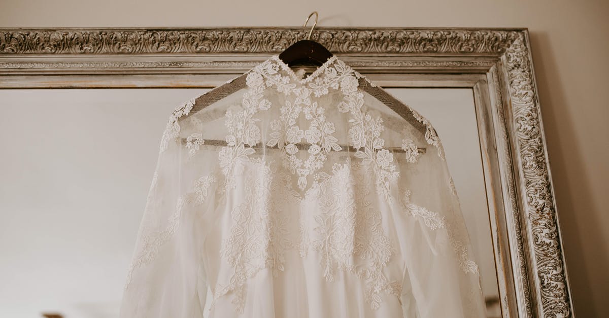 Is marriage certificate required to prove ties to home country? - Elegant bridal dress hanging on mirror Is marriage certificate required to prove ties to home country? - Elegant bridal dress hanging on mirror