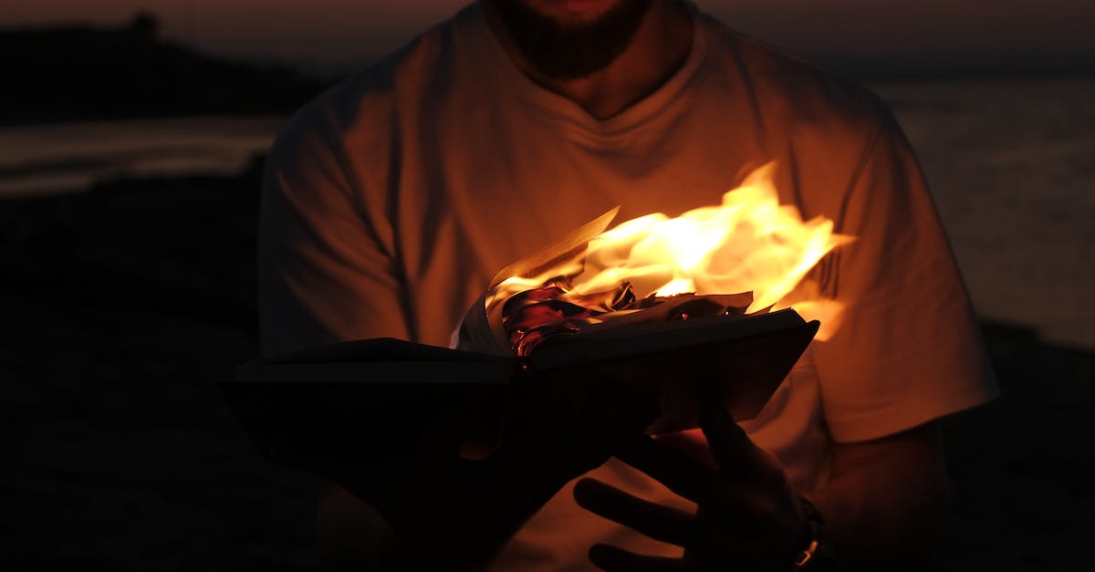 Is nudity as common at the Australian Burning Man as at the original US Burning Man? - A Man in White Shirt Holding a Burning Book Is nudity as common at the Australian Burning Man as at the original US Burning Man? - A Man in White Shirt Holding a Burning Book