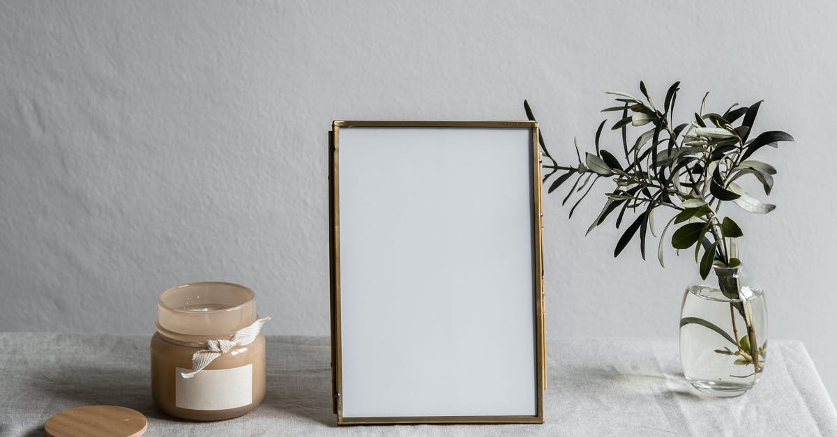 Is okay to bring an empty mason jar in your carry on? [closed] - Empty Photo Frame Between a Glass vase with Plant and Jar with Candle