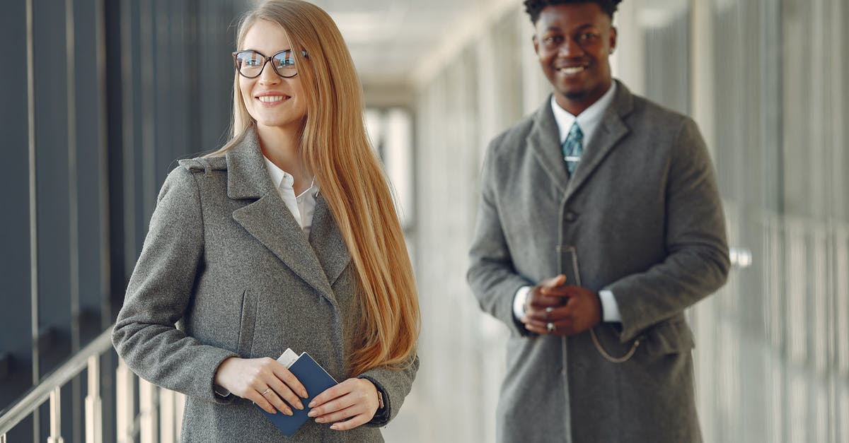 Is one hour between connecting flights at Heathrow Terminal 2 enough? - Cheerful business people with passport in airport hall Is one hour between connecting flights at Heathrow Terminal 2 enough? - Cheerful business people with passport in airport hall