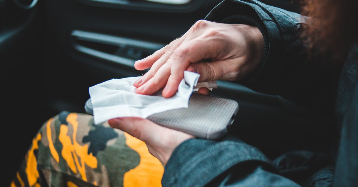 Is Portugal open to travel from Brazil and vice versa, by plane? Covid problems? - Crop person wiping smartphone with napkin Is Portugal open to travel from Brazil and vice versa, by plane? Covid problems? - Crop person wiping smartphone with napkin