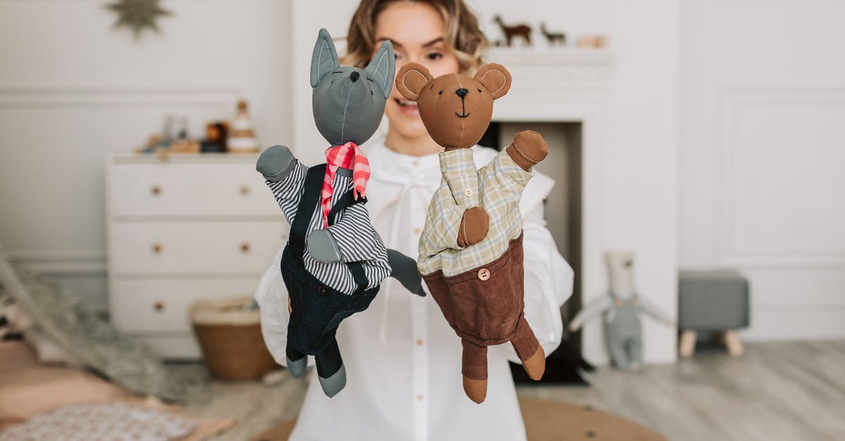 Is Prague known for their Marionette / Puppet shows? - A Woman Holding Two Plush Toy Puppets Is Prague known for their Marionette / Puppet shows? - A Woman Holding Two Plush Toy Puppets