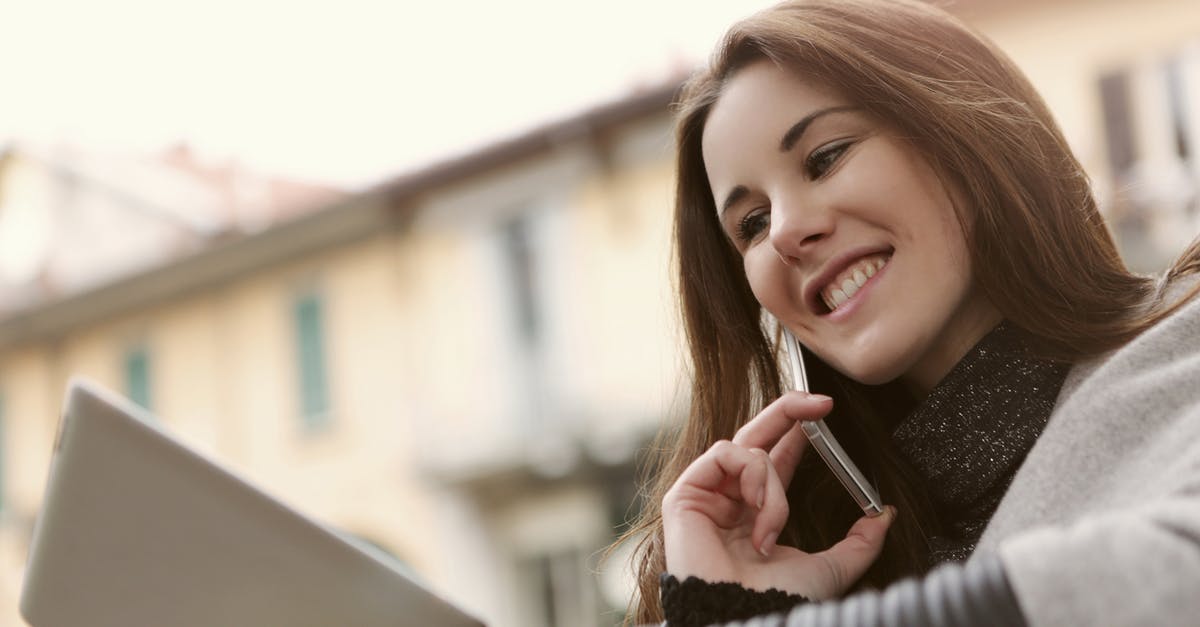 Is speaking Portuguese useful in Macau today? - Woman in Gray Sweater Holding Smartphone and Silver Tablet Is speaking Portuguese useful in Macau today? - Woman in Gray Sweater Holding Smartphone and Silver Tablet