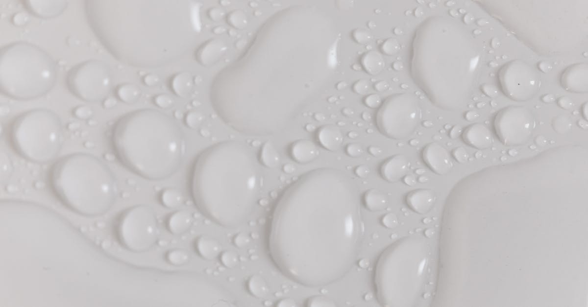 Is temporary I-551 still valid upon passport renewal? [closed] - Closeup top view of wet plain white background of droplet with translucent clean still water drops of different shapes and sizes