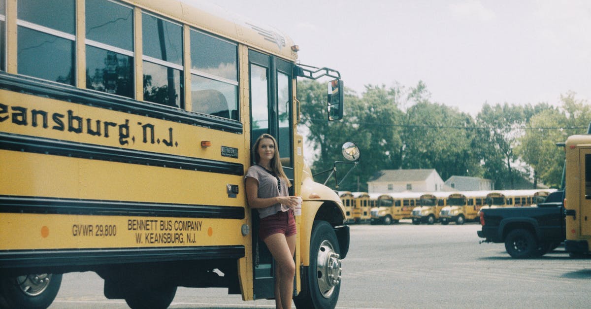 Is the late bus service from Val-d'Isère to Tignes running? - Cheerful woman standing near public bus Is the late bus service from Val-d'Isère to Tignes running? - Cheerful woman standing near public bus