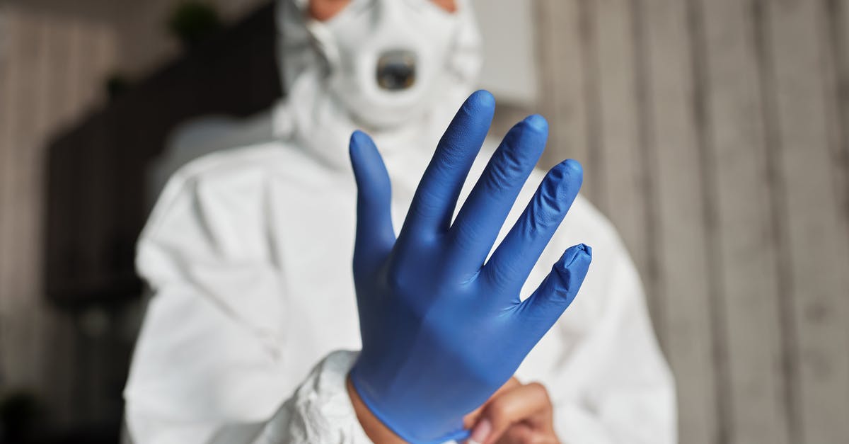 Is the Zika Virus Outbreak Expected to Lower Cost of Flights to South America? [closed] - Hand of a Person Wearing a Latex Glove