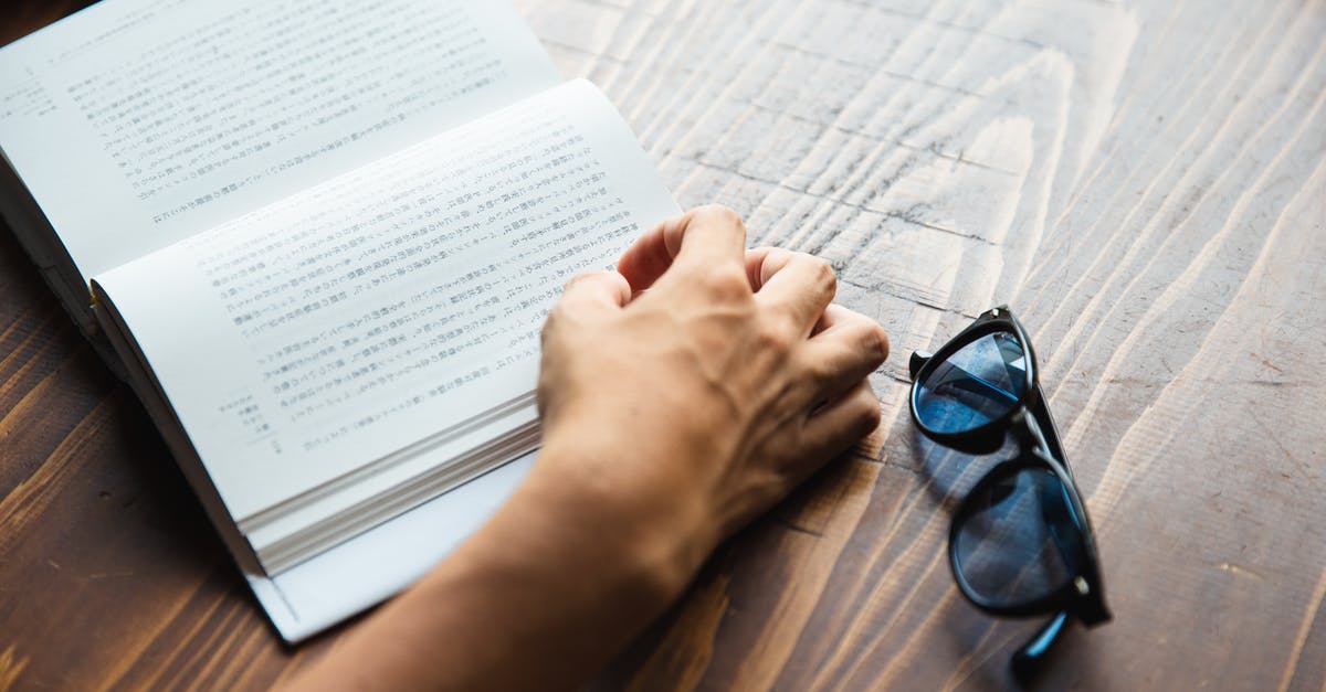 Is there a bookstore at Heathrow with a good selection of LP or Moon guides? - Crop faceless person sitting at table and reading book Is there a bookstore at Heathrow with a good selection of LP or Moon guides? - Crop faceless person sitting at table and reading book
