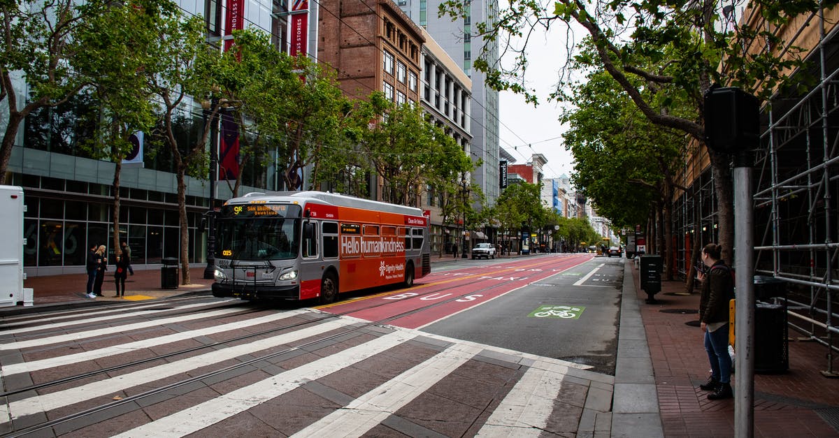 Is there a bus from San Francisco to Sonoma? - Red and Gray Passenger Bus Near High-rise Building Is there a bus from San Francisco to Sonoma? - Red and Gray Passenger Bus Near High-rise Building
