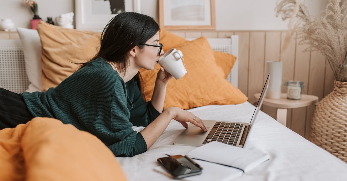 Is there a business class lounge at Noumea Tontouta airport? - Woman using laptop and drinking beverage in bed Is there a business class lounge at Noumea Tontouta airport? - Woman using laptop and drinking beverage in bed