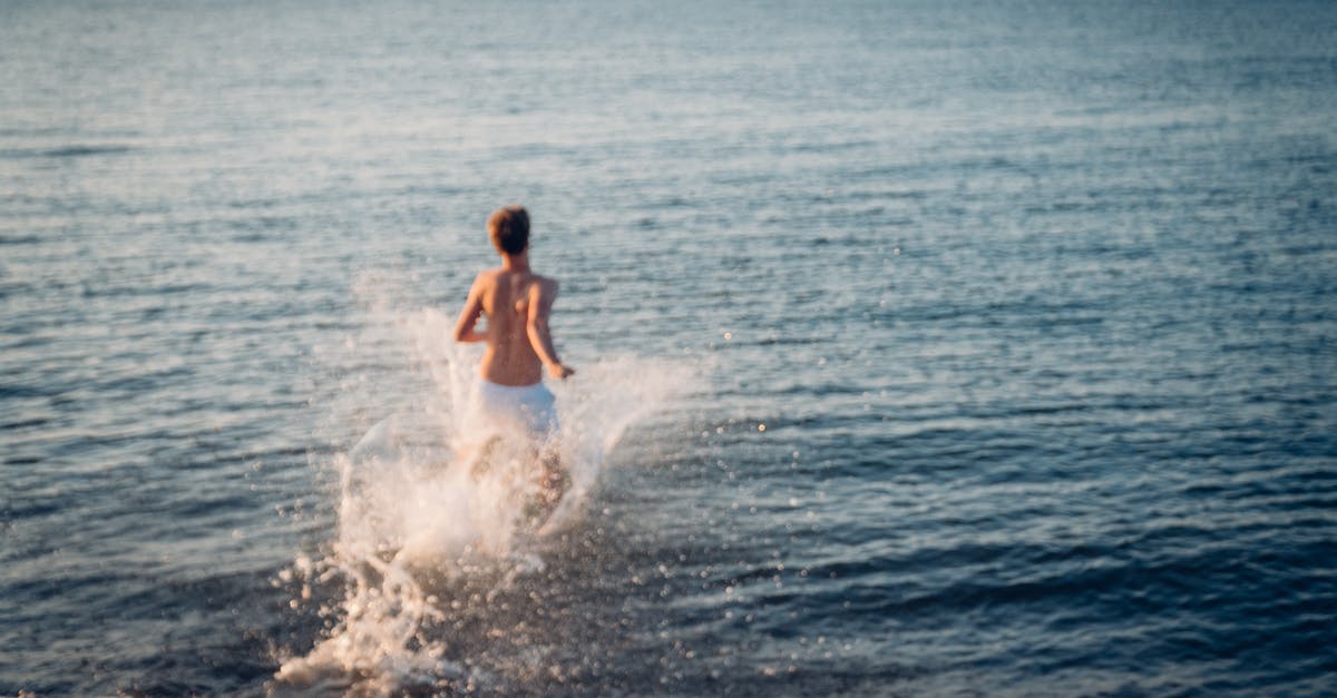 Is there a ferry running from UK to Scandinavia? - Back View of Man Running in Water Is there a ferry running from UK to Scandinavia? - Back View of Man Running in Water