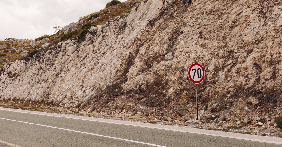 Is there a limit as to what distance airlines deliver delayed baggage? - Rock Formation beside an Empty Road 