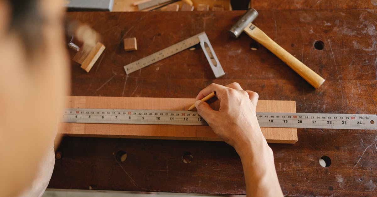 Is there a limit on the number of a single item I can take with me on a plane? - Top view of crop anonymous male measuring timber plank with ruler and marking with pencil while working on table with tools Is there a limit on the number of a single item I can take with me on a plane? - Top view of crop anonymous male measuring timber plank with ruler and marking with pencil while working on table with tools