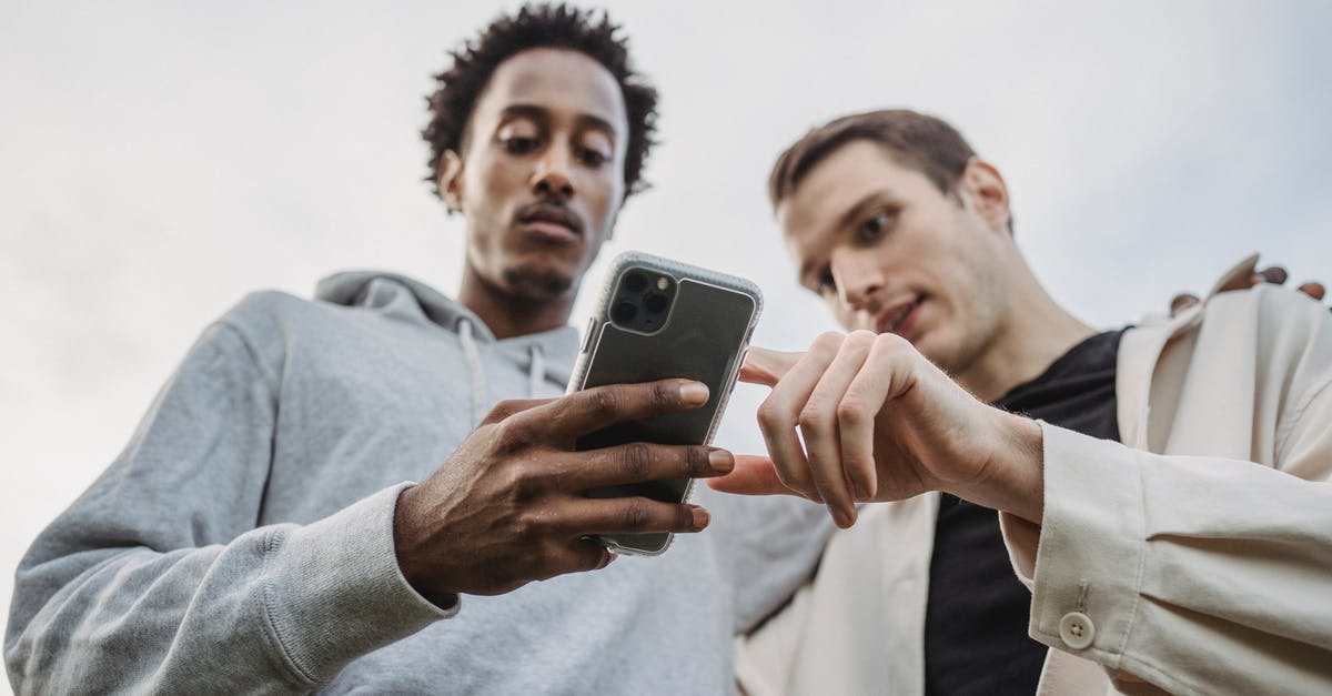 Is there a point in disclosing visa refusals from low-HDI countries when applying for visas from other countries? [closed] - Multiethnic friends browsing smartphone together outside