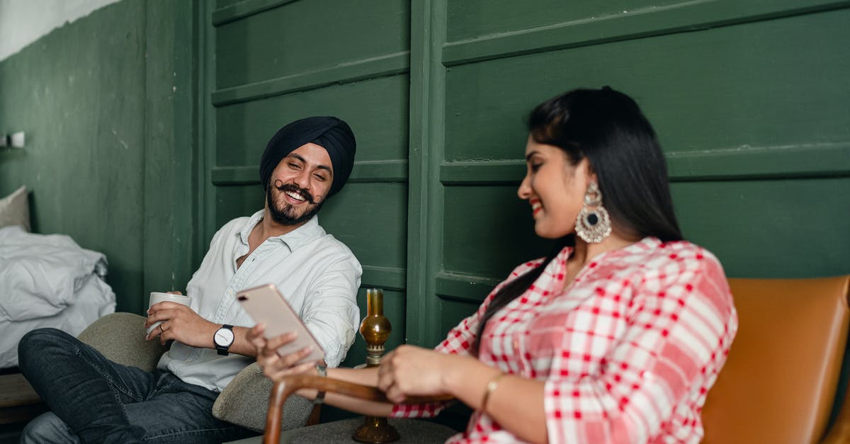 Is there a possibility to preserve an unused Indian mobile number for a period of time? - Happy married couple using smartphone and discussing funny Internet post Is there a possibility to preserve an unused Indian mobile number for a period of time? - Happy married couple using smartphone and discussing funny Internet post
