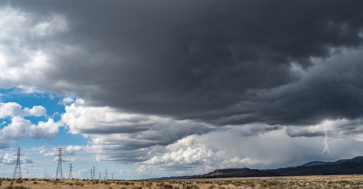 Is there a resource that lists dark sky reserves or similar places? - Breathtaking view of thick dark clouds on sky with lightning above uneven field with growing plants near metal towers and mountains in gloomy weather Is there a resource that lists dark sky reserves or similar places? - Breathtaking view of thick dark clouds on sky with lightning above uneven field with growing plants near metal towers and mountains in gloomy weather