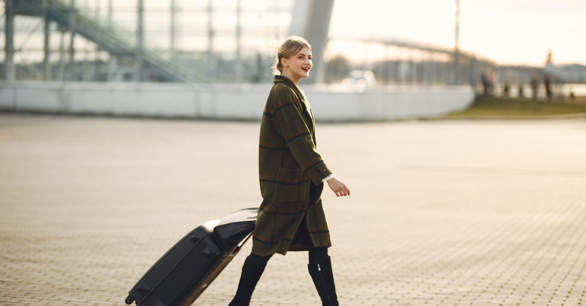 Is there a restaurant outside baggage claim, BOS Terminal E? - Full length of smiling female traveler in elegant outfit and high heeled boots walking near modern airport building with luggage and looking away