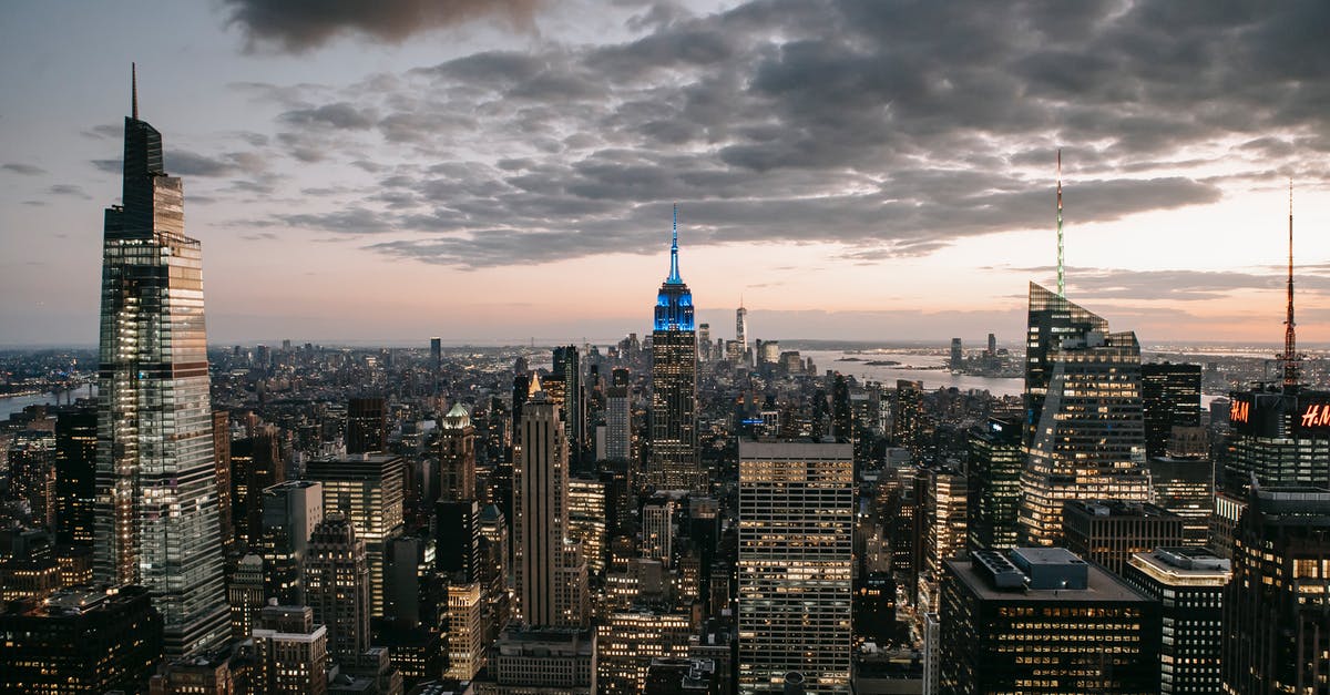 Is there a roof-top bar in the Empire State building? - Modern skyscraper exteriors against endless ocean under cloudy sky in New York City at sundown Is there a roof-top bar in the Empire State building? - Modern skyscraper exteriors against endless ocean under cloudy sky in New York City at sundown