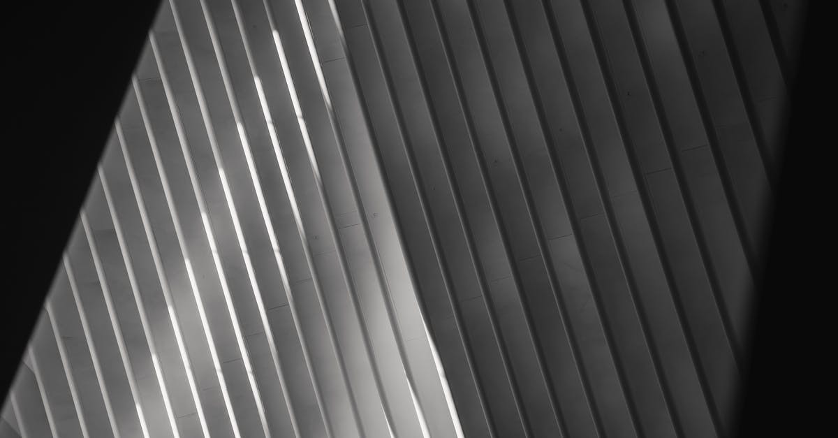 Is there a Schengen-wide database of long-term permits/visas, similar to the one used for short-term visas? - Abstract backdrop of modern building roof in sunlight