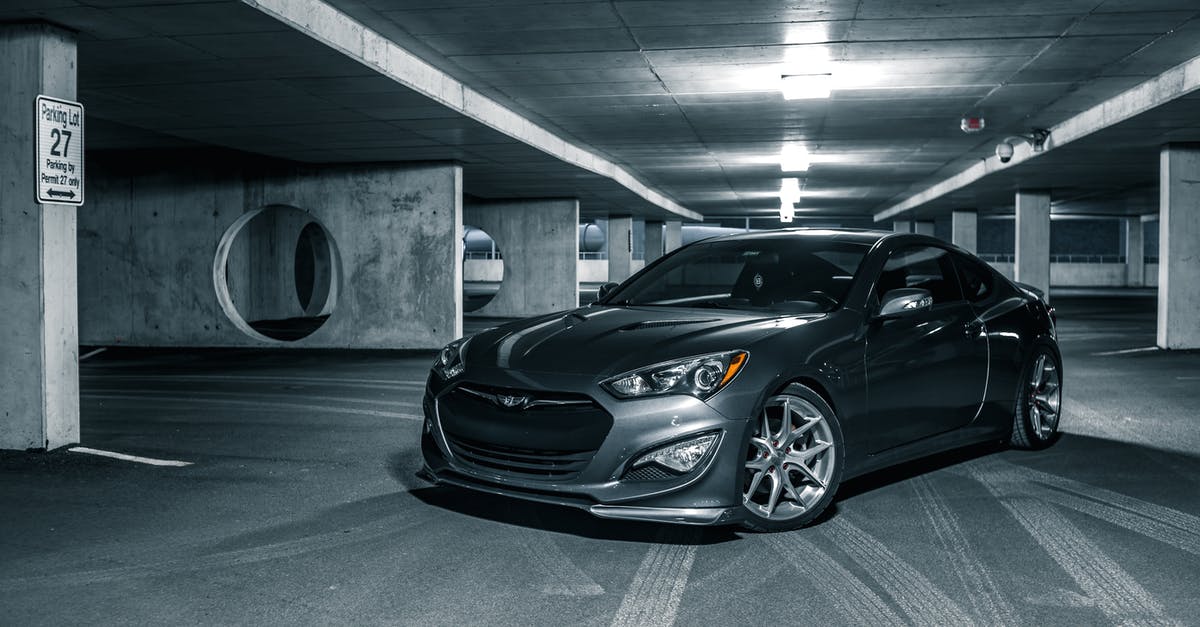 Is there a search engine for renting an electric car? - Selective color of gray luxury sports car parked on floor in center of car park Is there a search engine for renting an electric car? - Selective color of gray luxury sports car parked on floor in center of car park