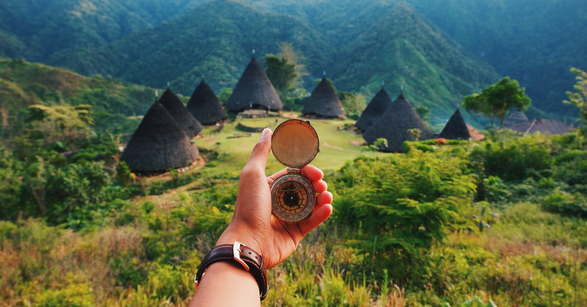 Is there a village in the mountains of central Asia that isn't very hot in August from where daytrips can be made without long drives? [closed] - Person Holding A Compass