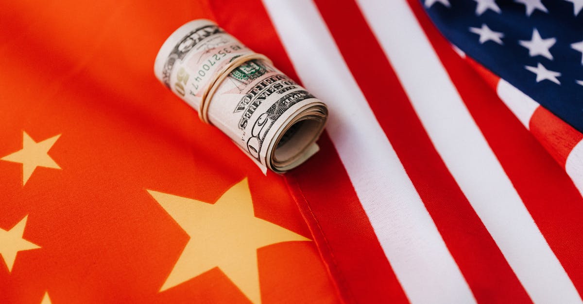 Is there a website that lists budget airlines for each country? - Colorful flag of America and roll of paper bills
