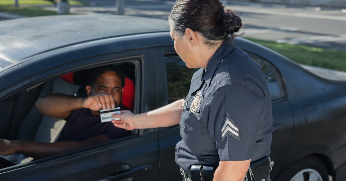 Is there an easyJet ticket office in Schönefeld? - Man Giving His Driver's License to the Policewoman Is there an easyJet ticket office in Schönefeld? - Man Giving His Driver's License to the Policewoman