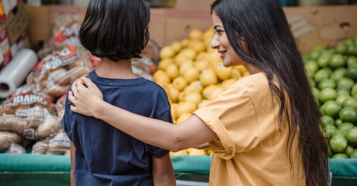 Is there an Indian food market in Montevideo? - Woman in Yellow T-shirt Holding Yellow Fruit