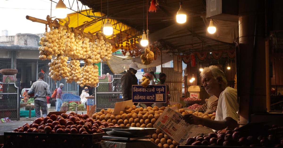Is there an Indian food market in Montevideo? - An Elderly Man Selling Vegetables in a Stall