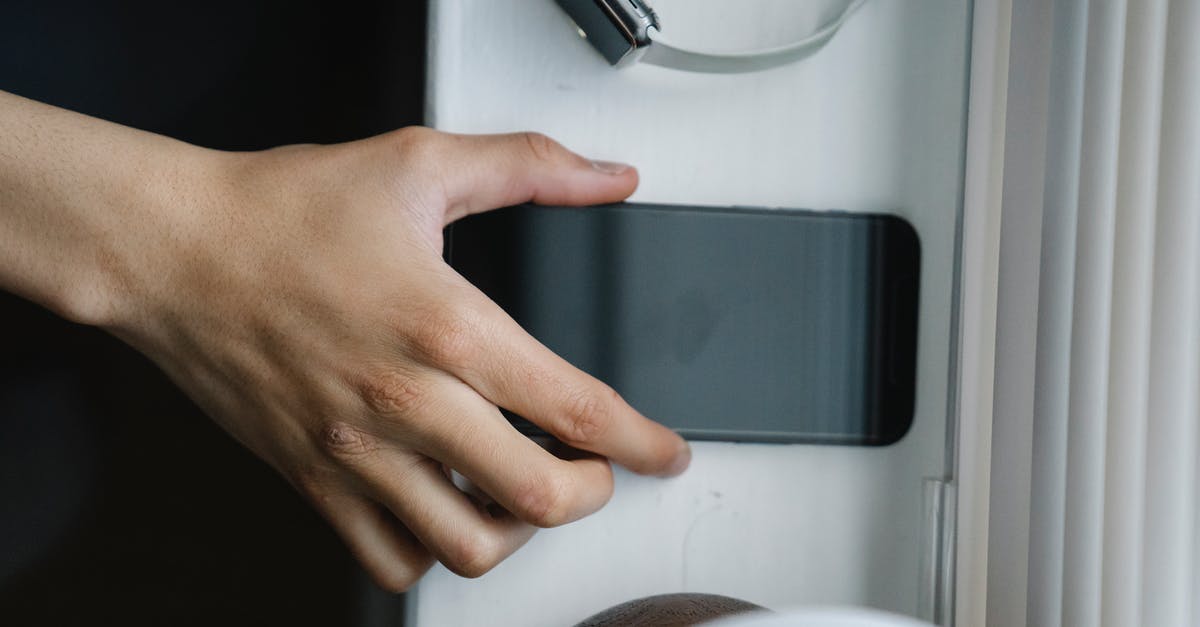 Is there an inexpensive way to get from Rovinj to Pula airport early in the morning in the offseason? - Top view of anonymous person taking cellphone with black screen from windowsill near wristwatch at home Is there an inexpensive way to get from Rovinj to Pula airport early in the morning in the offseason? - Top view of anonymous person taking cellphone with black screen from windowsill near wristwatch at home