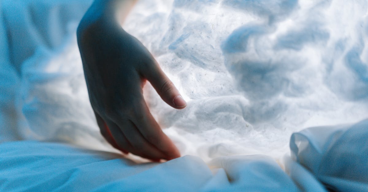 Is there an inflatable pillow that can be inflated by hand : a piston, hand pump or a rotating handle? [closed] - Persons Hand on White Textile