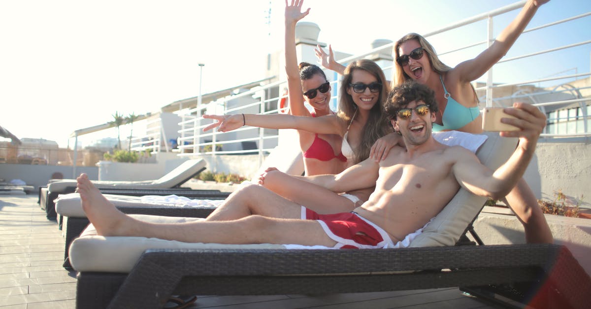 Is there any advantage of using a travel agent in this day and age? [duplicate] - Happy friends chilling on poolside