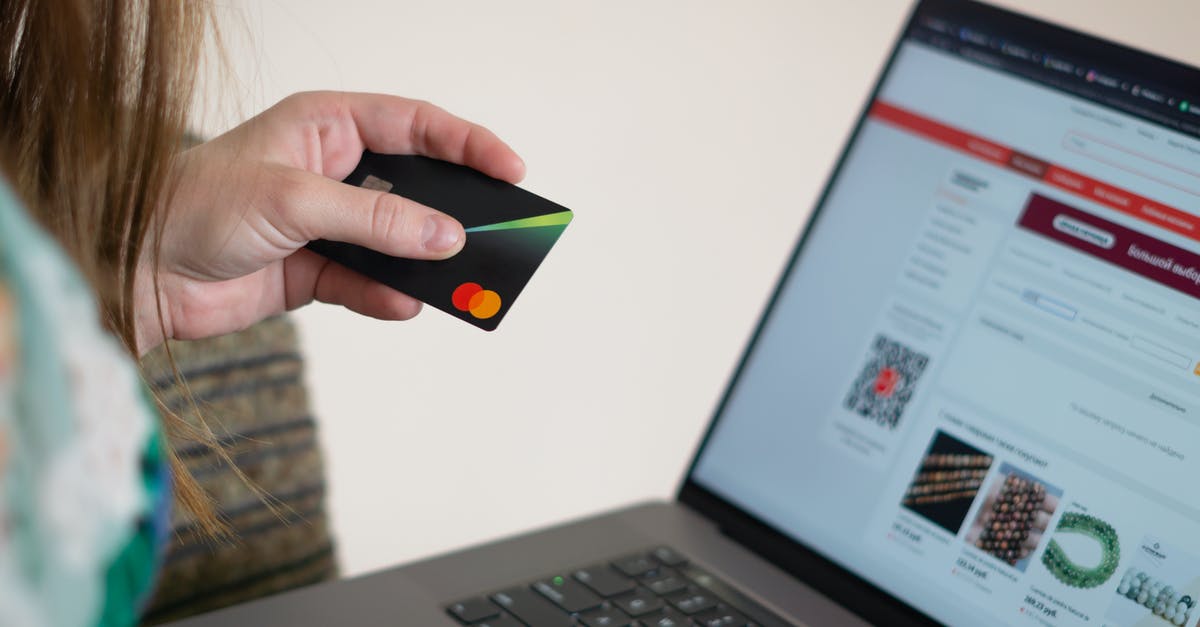 Is there any bank that issues free ATM cards and accounts in Cambodia? [closed] - Person Holding Black and Orange Smartphone