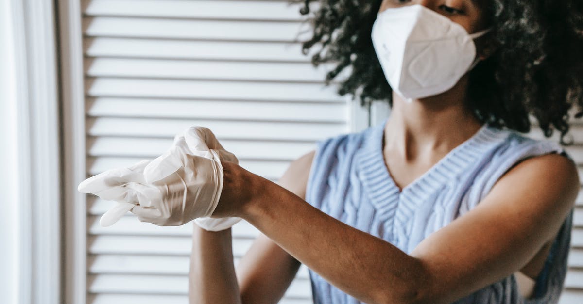 Is there any COVID restriction to do a layover in Paris, France? - Young African American female in white protective face mask putting of medical latex gloves Is there any COVID restriction to do a layover in Paris, France? - Young African American female in white protective face mask putting of medical latex gloves