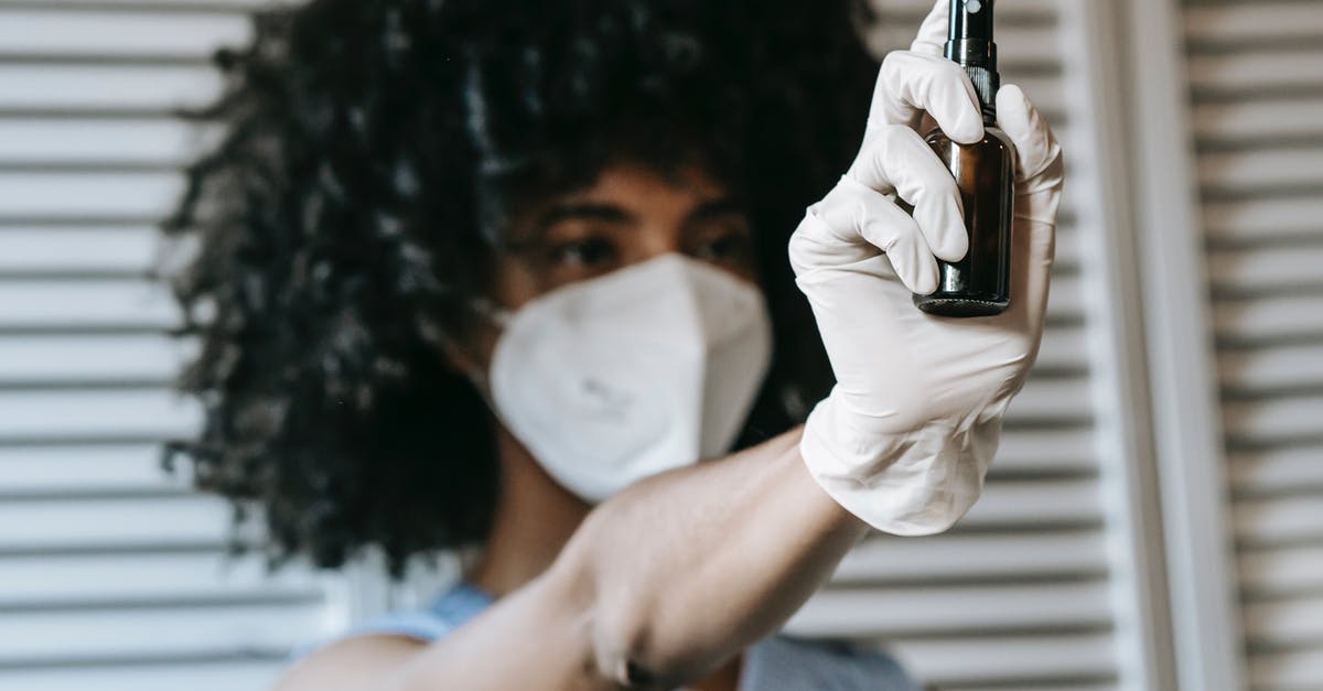 Is there any COVID restriction to do a layover in Paris, France? - Woman spraying antiseptic in room Is there any COVID restriction to do a layover in Paris, France? - Woman spraying antiseptic in room
