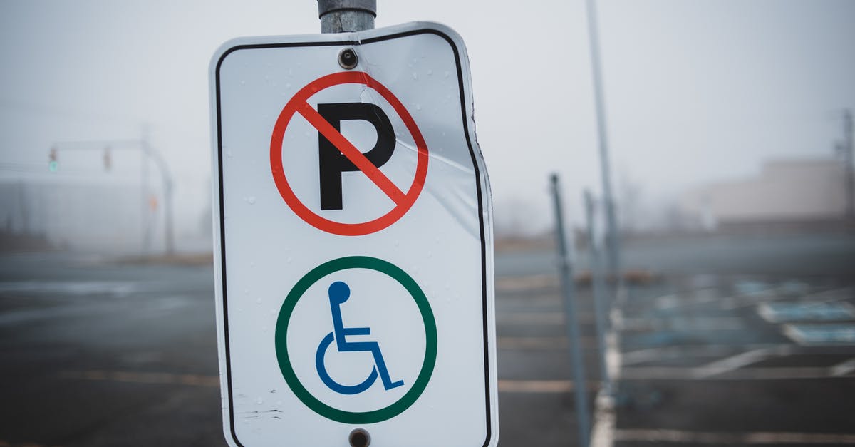Is there any easy and cheap way to obtain an invitation to any Schengen zone country? - White disabled parking sign on post located on empty asphalt parking lot with marking line on street in foggy weather Is there any easy and cheap way to obtain an invitation to any Schengen zone country? - White disabled parking sign on post located on empty asphalt parking lot with marking line on street in foggy weather