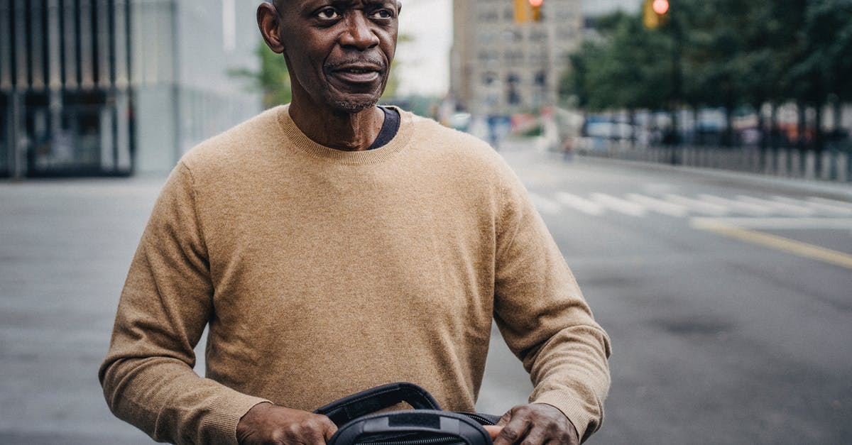 Is there any personal benefit in formally cancelling a (non-refundable) flight? - Focused black businessman with personal bag in downtown
