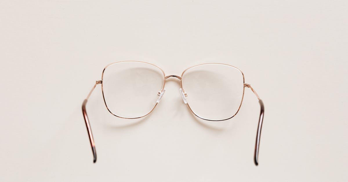 Is there anything to actually see in Srebrenica? - Top view of fashion spectacles with transparent optical lenses in golden metal shell placed on white table Is there anything to actually see in Srebrenica? - Top view of fashion spectacles with transparent optical lenses in golden metal shell placed on white table