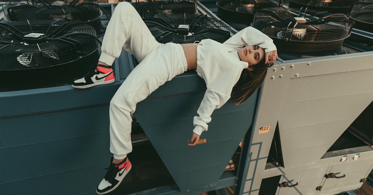 Is there camping gear specifically designed to fit modern air traveling? - Full body of stylish female with long hair looking at camera while lying with bent leg on edge of compressor air conditioner on roof Is there camping gear specifically designed to fit modern air traveling? - Full body of stylish female with long hair looking at camera while lying with bent leg on edge of compressor air conditioner on roof