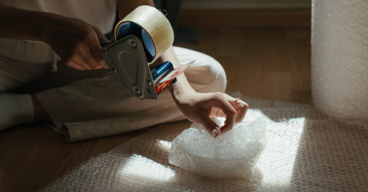 Is there plastic wrapping center at Stuttgart Airport? - Person Holding White and Black Vr Goggles Is there plastic wrapping center at Stuttgart Airport? - Person Holding White and Black Vr Goggles