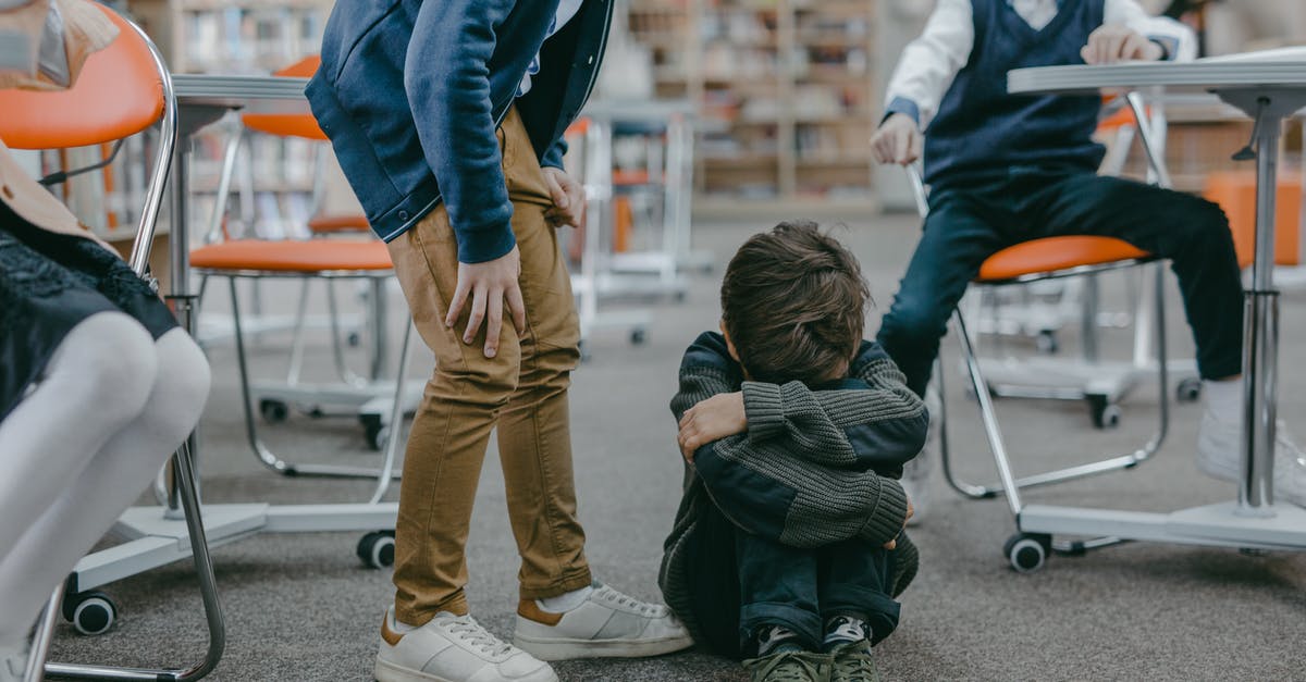 Is there racism in Estonia? - Sad Boy in Gray Sweater Sitting on the Floor Is there racism in Estonia? - Sad Boy in Gray Sweater Sitting on the Floor