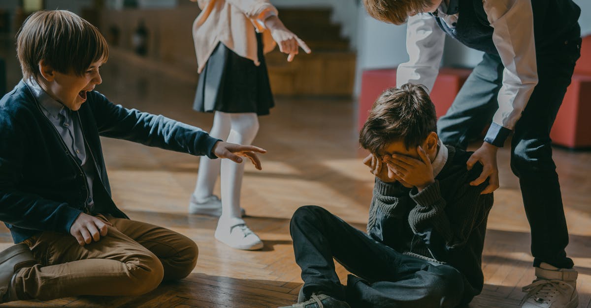 Is there racism in Estonia? - Children Finger Pointing at a Boy Sitting on a Wooden Floor Is there racism in Estonia? - Children Finger Pointing at a Boy Sitting on a Wooden Floor